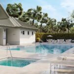 A pool area with loungers and palm trees.