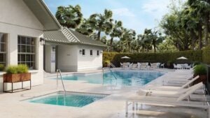 A pool area with loungers and palm trees.