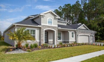 Beautiful modern suburban house in Odessa, FL with lush garden and clear blue sky. {{brizy_dc_image_alt entityId=