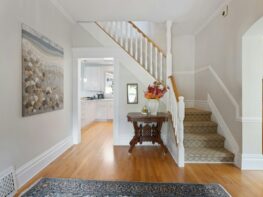Photo by Point3D Commercial Imaging Ltd. a hallway with a wooden floor and a painting on the wall