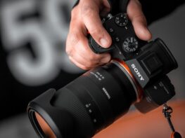 person holding black Sony DSLR camera